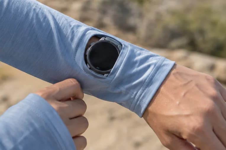 Illustrative running watch visible through a sleeve opening