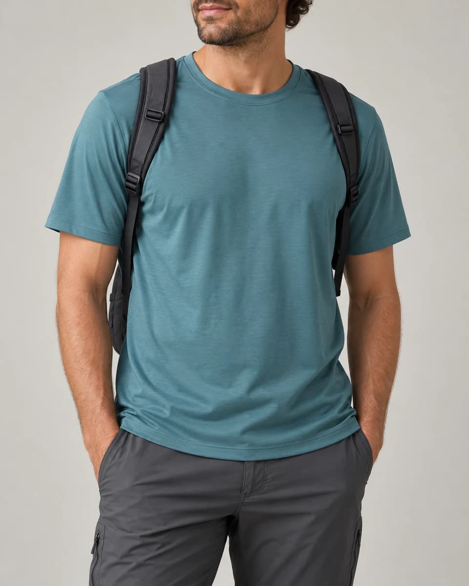 Generated category example of a man in a teal short-sleeve tee with a daypack; not the REI product