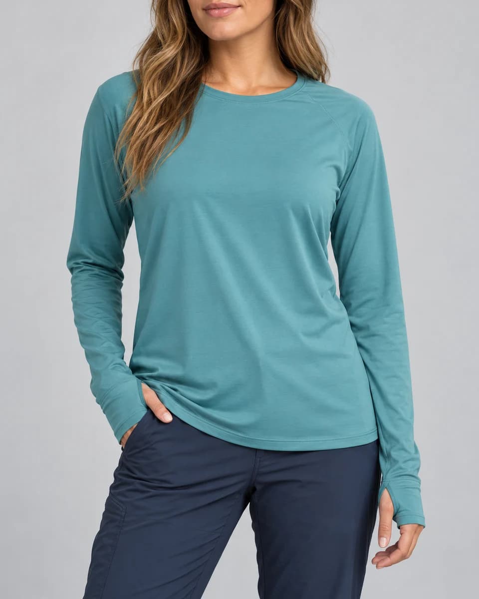 Generated category example of a woman in an unbranded teal long-sleeve crew with thumbholes; not the AFTCO W61126 product